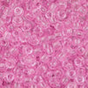 A close-up view of small, translucent pink pony beads for jewelry making and craft projects.