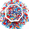 A pile of colorful polymer clay sprinkles mix in various rainbow and solid colors, including red, blue, and white accents.