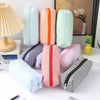 A collection of striped canvas pencil cases in various colors and patterns, including pink, orange, mint green, and black str