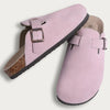 Pink suede cork mules with a leather strap and arch support visible from the side.
