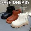 A set of cozy kids winter boots in brown, tan, and cream faux leather finishes displayed on a gray surface.