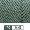 Close-up of a gray yarn texture showing a knitted cable pattern.
