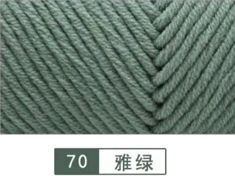 Close-up of a gray yarn texture showing a knitted cable pattern.