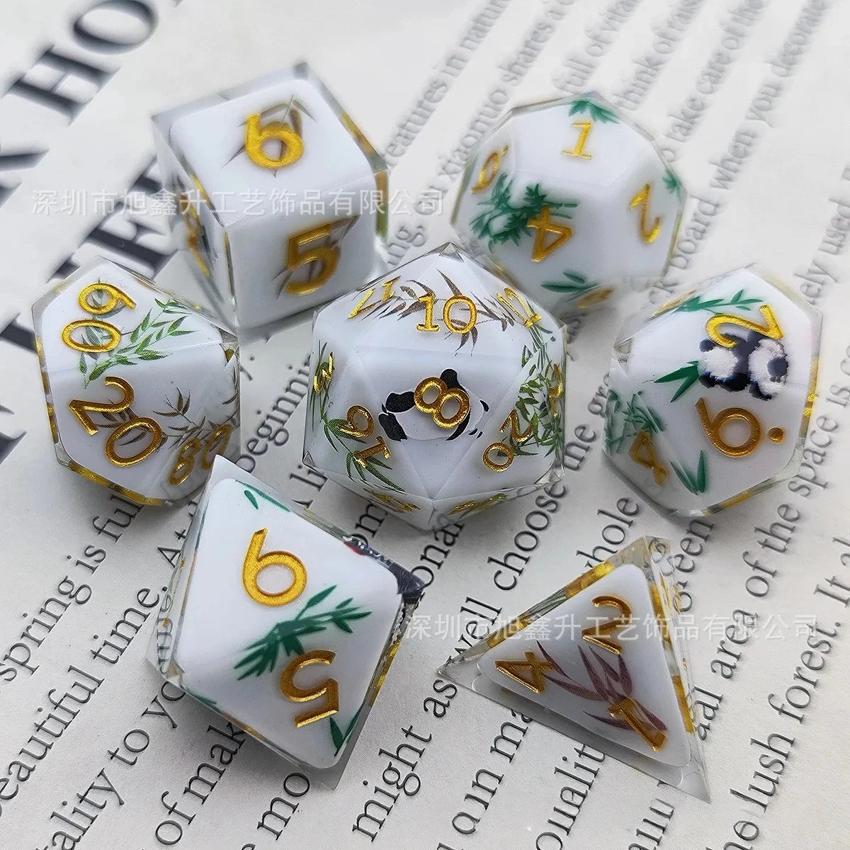 A set of milk white resin dice featuring gold accents and a black kitten design.
