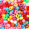 A collection of colorful rainbow pony beads in various shades including pink, yellow, green, and red.