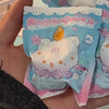 A close-up of a cute mini bean blind box figurine featuring an octopus cat pendant charm with pink and blue floral accents.