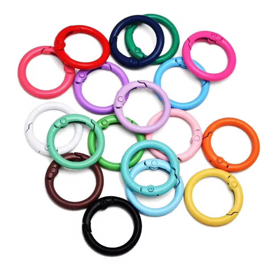 A collection of colorful alloy snap hook keychain clips in various colors like red, pink, green, and blue.
