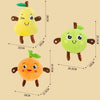 Three yellow and orange fruit plush toys with ears, shown against a beige background.
