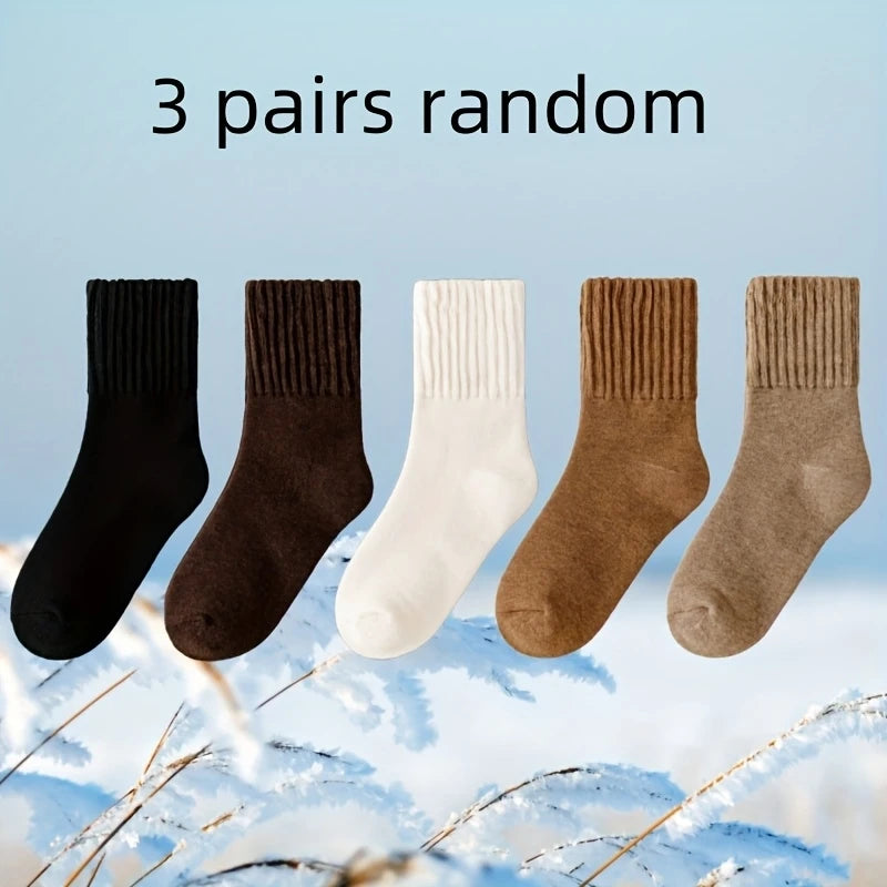 Three pairs of random women's fleece-lined slouch socks in black, brown, white, and tan.