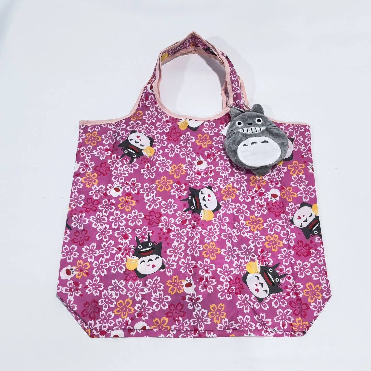 A pink fabric pouch featuring a repeating pattern of small black and white hippo faces on a white background.