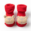 Pair of red knitted baby anti-slip cotton socks with festive Christmas bear designs