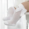 White lace knee socks for a baby girl with a decorative bow