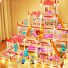 A brightly lit miniature castle and villa playset featuring pink and orange structures and figures.