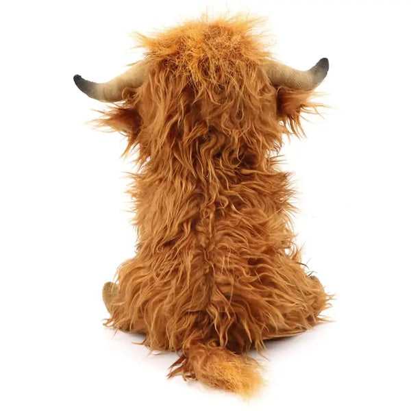 Peluche de vaca Highland naranja-marrón y esponjosa con pelo largo y desgreñado.