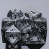 A collection of seven clear polyhedral dice, including a d20 and d10, resting on a dark surface.