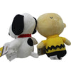 A soft collectible plush toy of Snoopy with a black and white body and a yellow shirt.