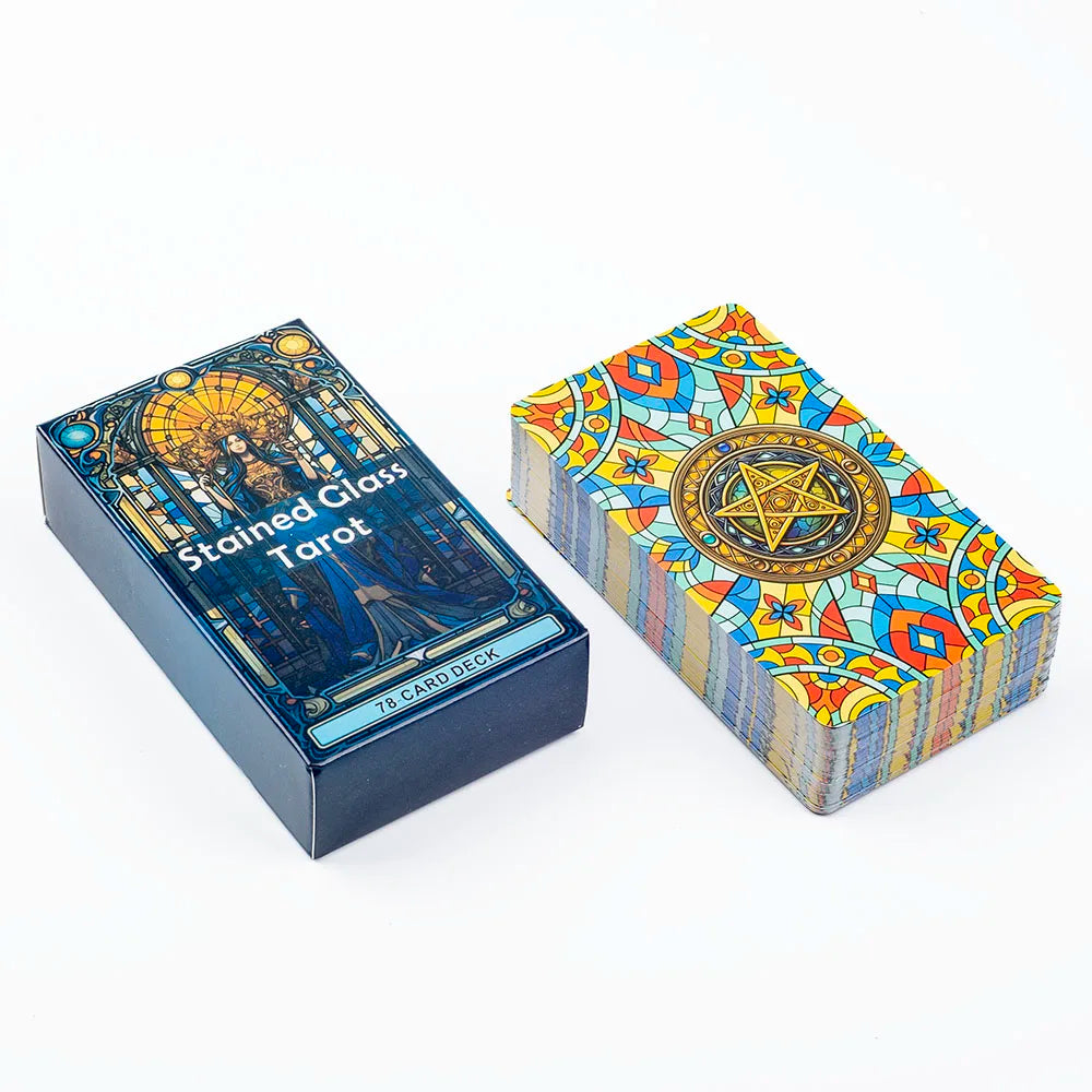 A box of the Stained Glass Tarot Card Deck featuring colorful, intricate designs and a gold-accented symbol.