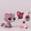 A pink and white shorthair cat bobble head figurine with large eyes and pink ears.