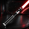 A black lightsaber with a red blade is displayed on a dark surface against a starry background.