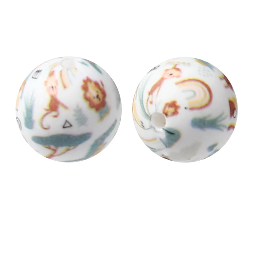Two white silicone beads decorated with colorful animal and nature prints for jewelry making