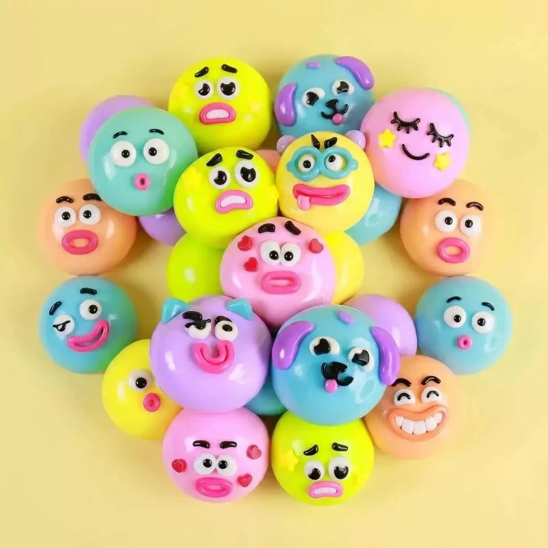 A collection of colorful, moldable dog face squishy sensory toys in various shades of pink, yellow, and blue.