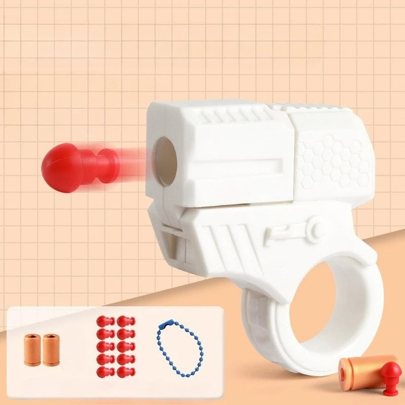 White mini shell-ejecting fidget pistol with red shells and a blue bead shown on a light background