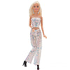 A fashion doll wearing a light pink sequin top and matching trousers set