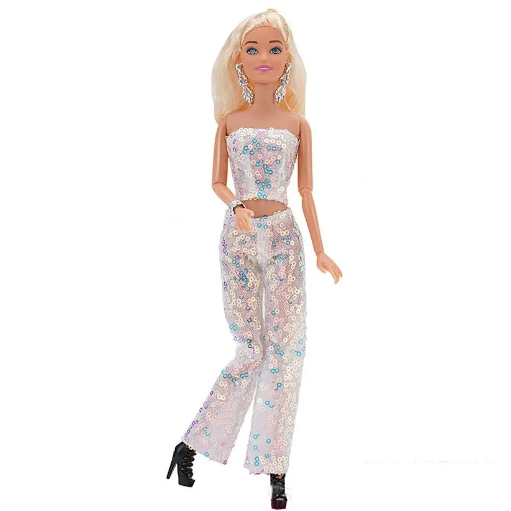 A fashion doll wearing a light pink sequin top and matching trousers set
