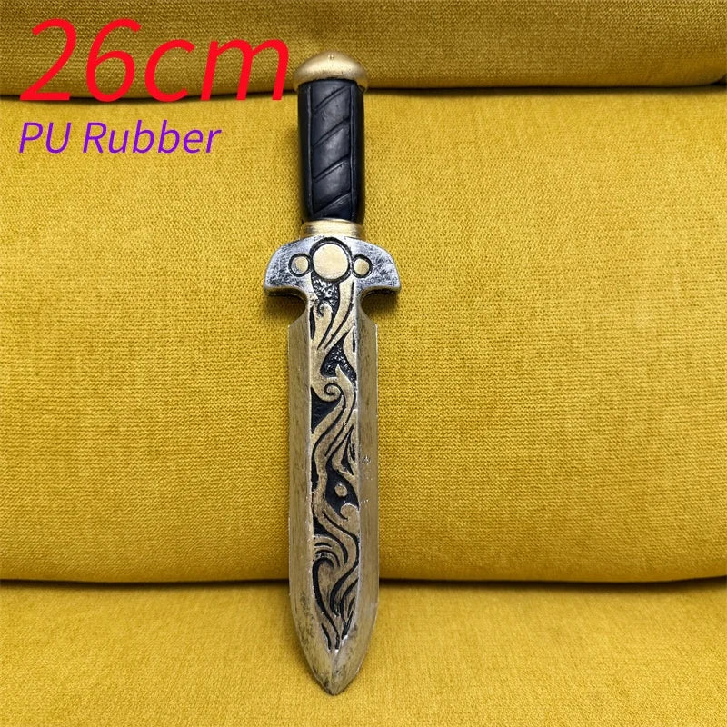 A handcrafted dagger with a silver blade and dark handle, displayed on a yellow fabric background.