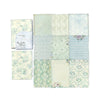 A collection of vintage paper sheets featuring various light green, blue, and cream tones with floral and striped patterns.