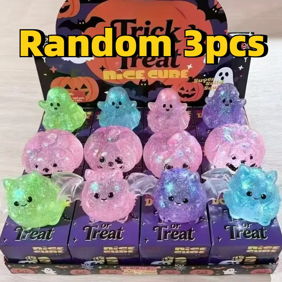 A box of Random 3pcs Treat Nice Cube stress relief balls featuring various colored and glittery ghost and bat shapes.