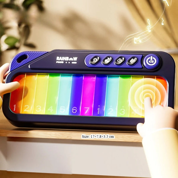 A hand is playing a Rainbow Piano Keyboard musical toy with colorful plastic bars.