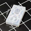 A clear silicone mold shaped like a bear, used for resin jewelry and crafts, shown on a grid background.