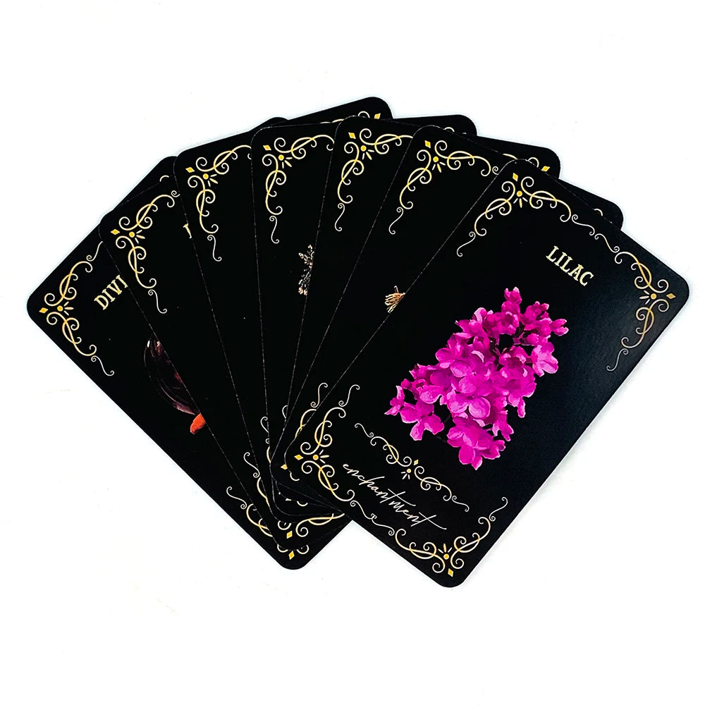 A stack of black oracle cards featuring a lilac design and gold accents.