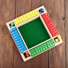 A wooden dice game board with colored dice and numbered slots for 2 to 4 players.