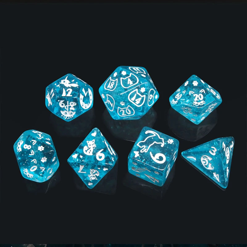 A set of seven blue polyhedral dice with gold numbering arranged on a dark surface.