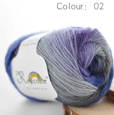 A ball of grey and purple merino wool yarn is shown, labeled as colour 02.
