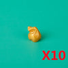 A small, golden building block shaped like a treasure chest is shown against a teal background with the text X10.