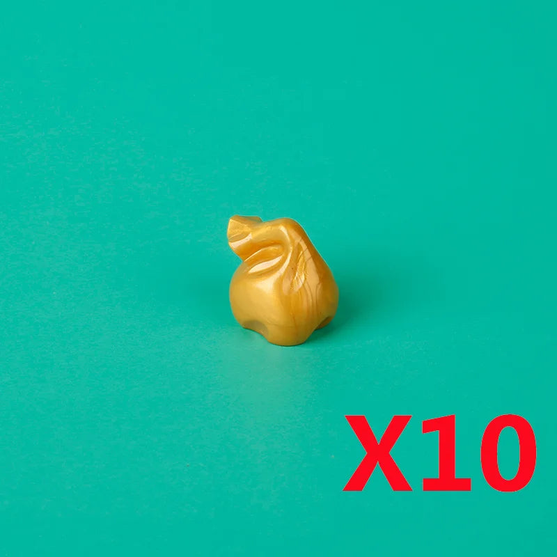 A small, golden building block shaped like a treasure chest is shown against a teal background with the text X10.