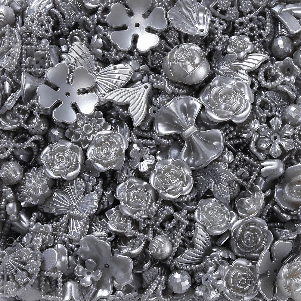 A close-up view of silver and iridescent butterfly shell acrylic beads for DIY jewelry making.