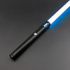 A black lightsaber toy with a glowing blue blade is shown diagonally on a dark gray surface.