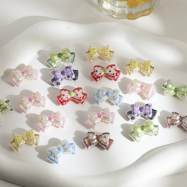 A collection of colorful, glittery acrylic jewelry findings beads arranged on a white surface.