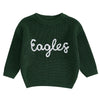 A dark green knit sweater for a baby or kid with white embroidered text that reads Eagles