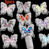 A collection of nine sparkling crystal butterfly beads in various colors and sizes for jewelry making