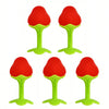 Four soft silicone fruit-shaped baby teethers in red and lime green colors.