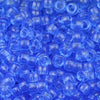 A close-up view of small, translucent blue pony beads scattered in a pile.