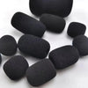 A collection of ten black foam covers for replacement microphone heads arranged in a circle.