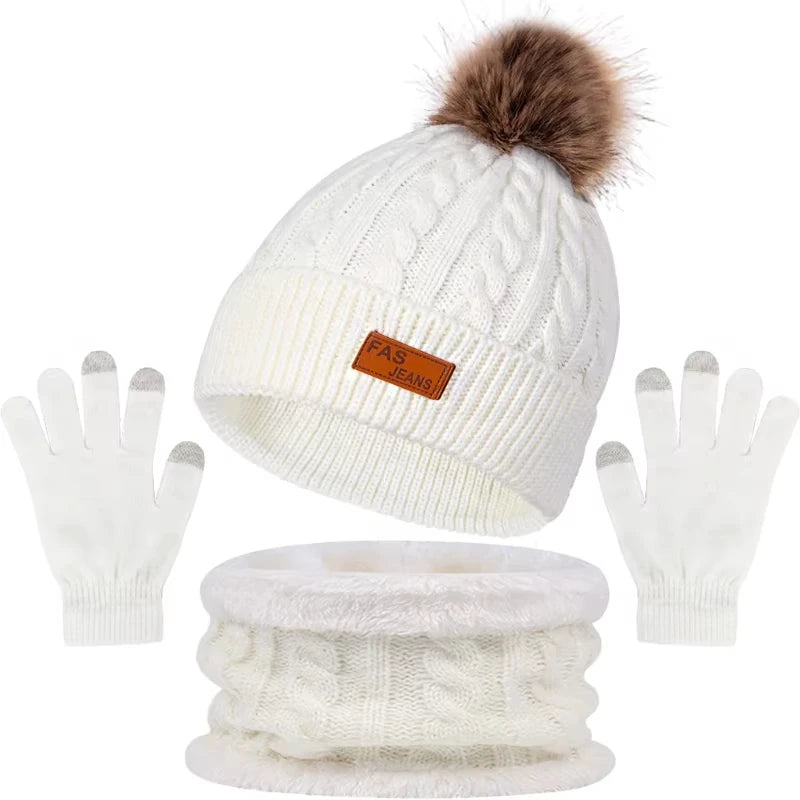 A set of white knit winter hat, scarf, and gloves with a faux fur pom.