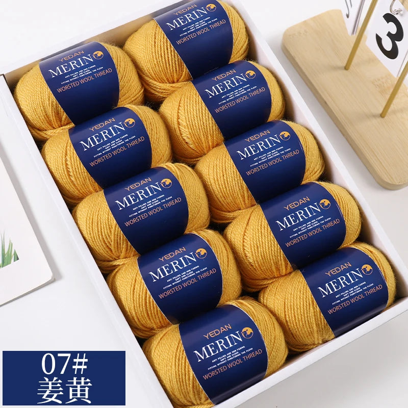 A box of yellow merino wool yarn balls with blue labels for knitting projects