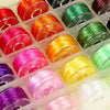A collection of colorful elastic crystal beading cords in various shades including red, orange, green, pink, and purple.